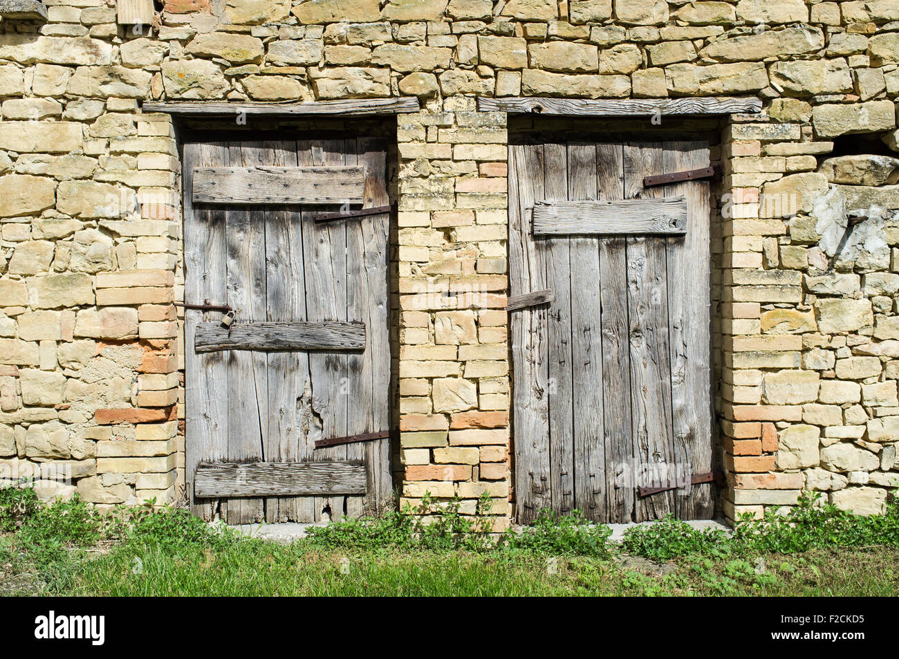 Old Stone Barn in Le Marche Italy with Two Weathered Wooden Doors Stock Photo