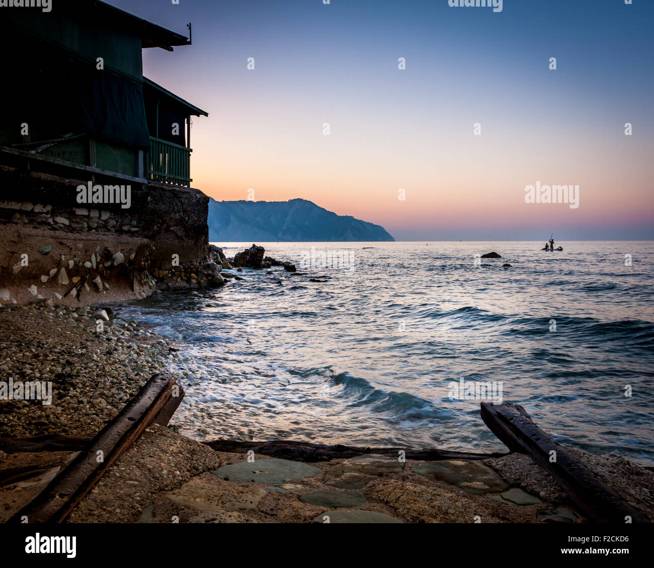 Old rail drive you into the wave on sunset Stock Photo - Alamy
