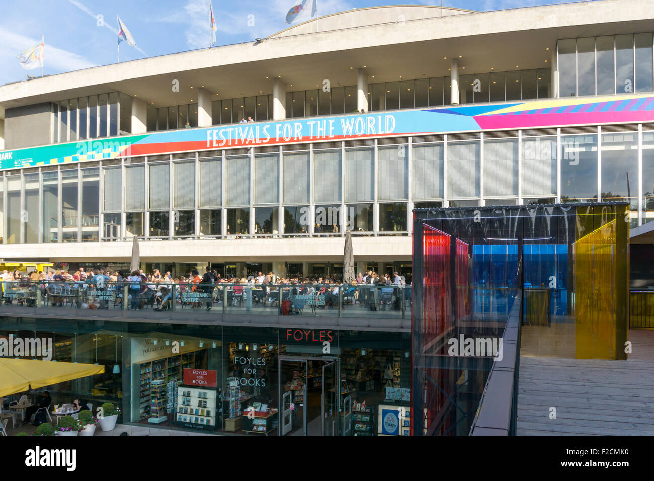 People eating & drinking outside the Royal Festival Hall on London's South Bank. Stock Photo