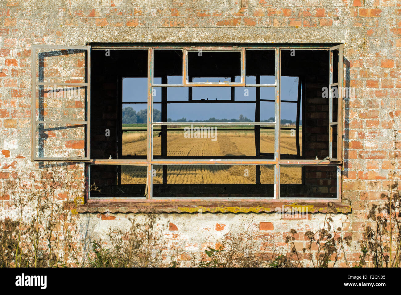 View through a window in an old farm building in the fens, Cambridgeshire Stock Photo