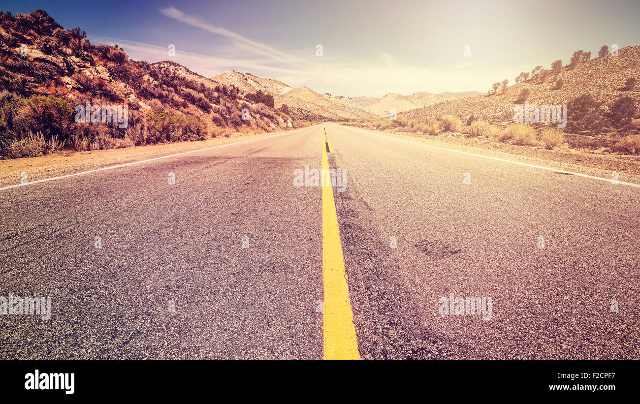 Retro vintage old film style endless country road, travel adventure concept, space for text, USA. Stock Photo