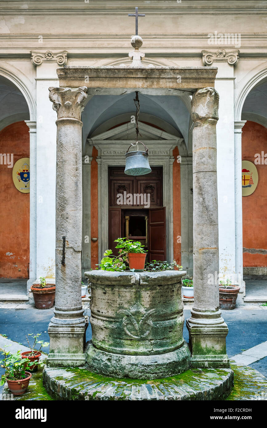 Courtyard and well outside the church of Saint Agata of Goti, Rome, Italy Stock Photo