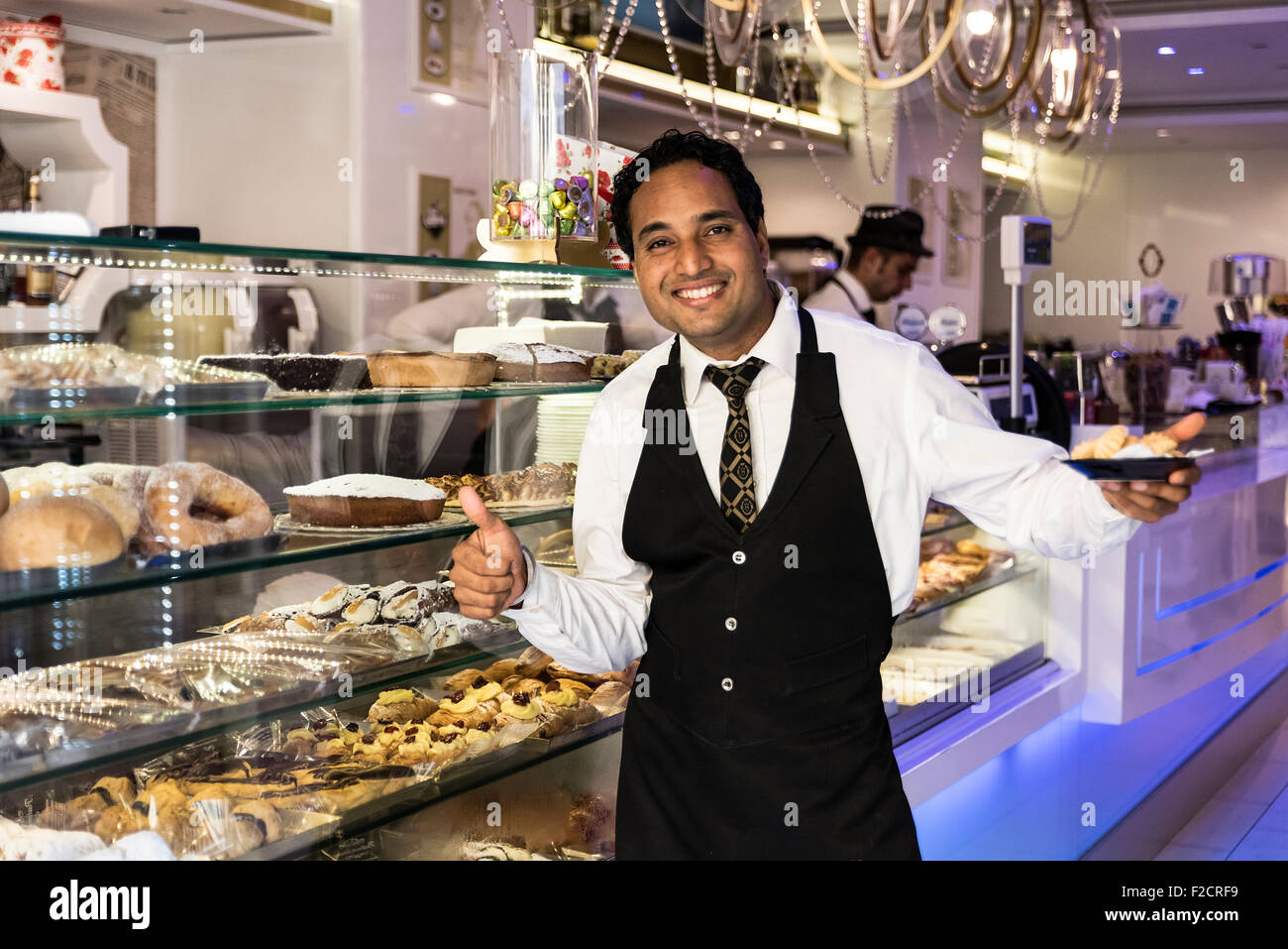 Greetings, service and samples from a pastry shop employee, Sorrento, Italy Stock Photo