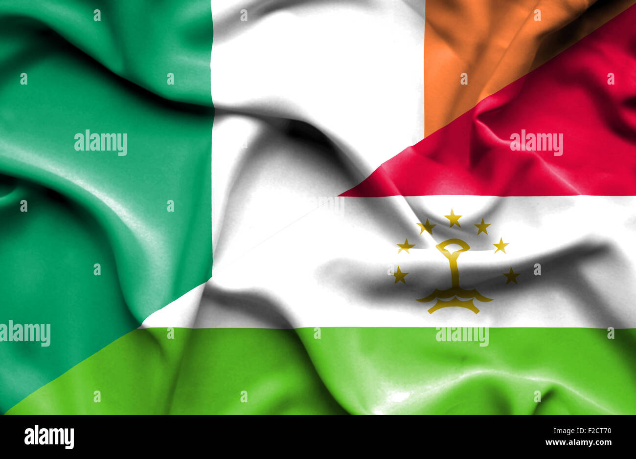 Waving flag of Tajikistan and Ireland Stock Photo