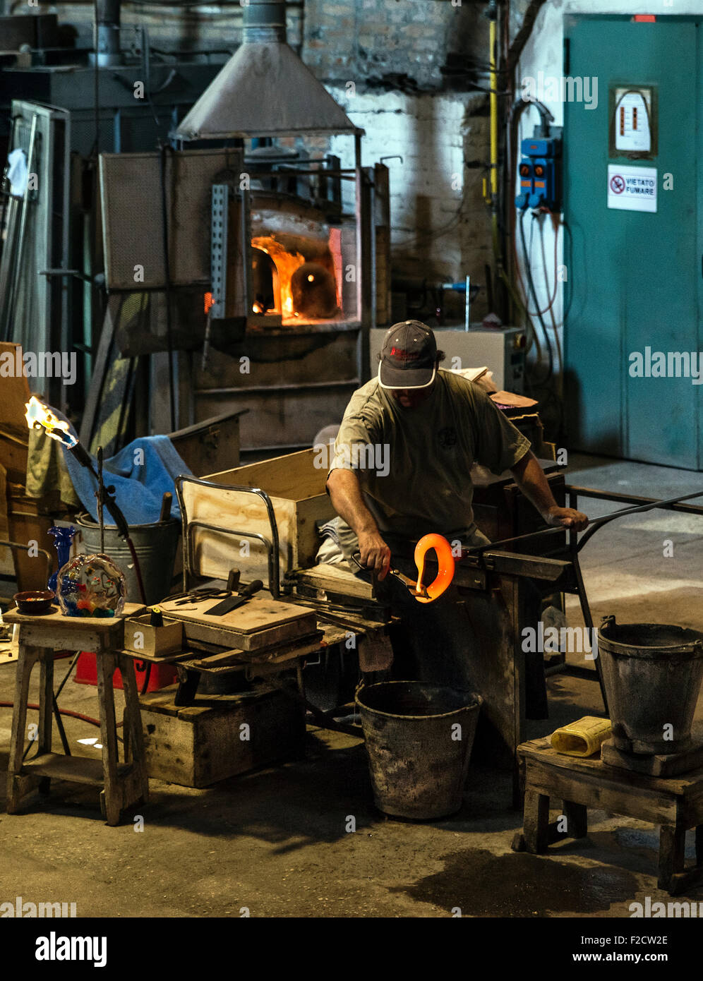Glassmith working, Venitian island of Murano, Italy. Famous for it's many furnaces and hand made glass. Stock Photo