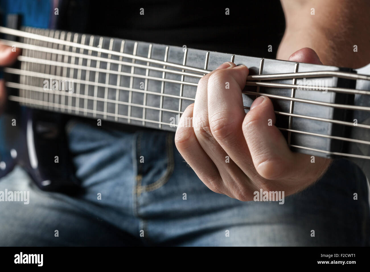 male musician playing on sixstring bass guitar Stock Photo Alamy