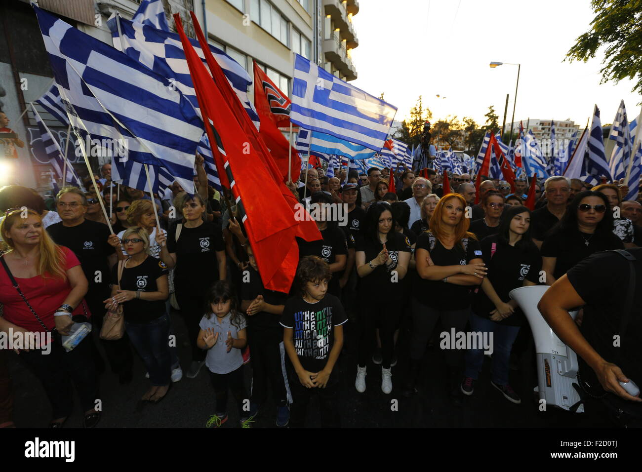 Athens, Greece. 16th September 2015. Golden Dawn supporters wave Greek and Golden Dawn flags  at the election rally in Athens. Greek right wing  party Golden Dawn held an election rally in Athens, four days ahead of election day. The party hopes to gain enough seats in the election to become the third latest party in the Greek Parliament. Credit:  Michael Debets/Alamy Live News Stock Photo