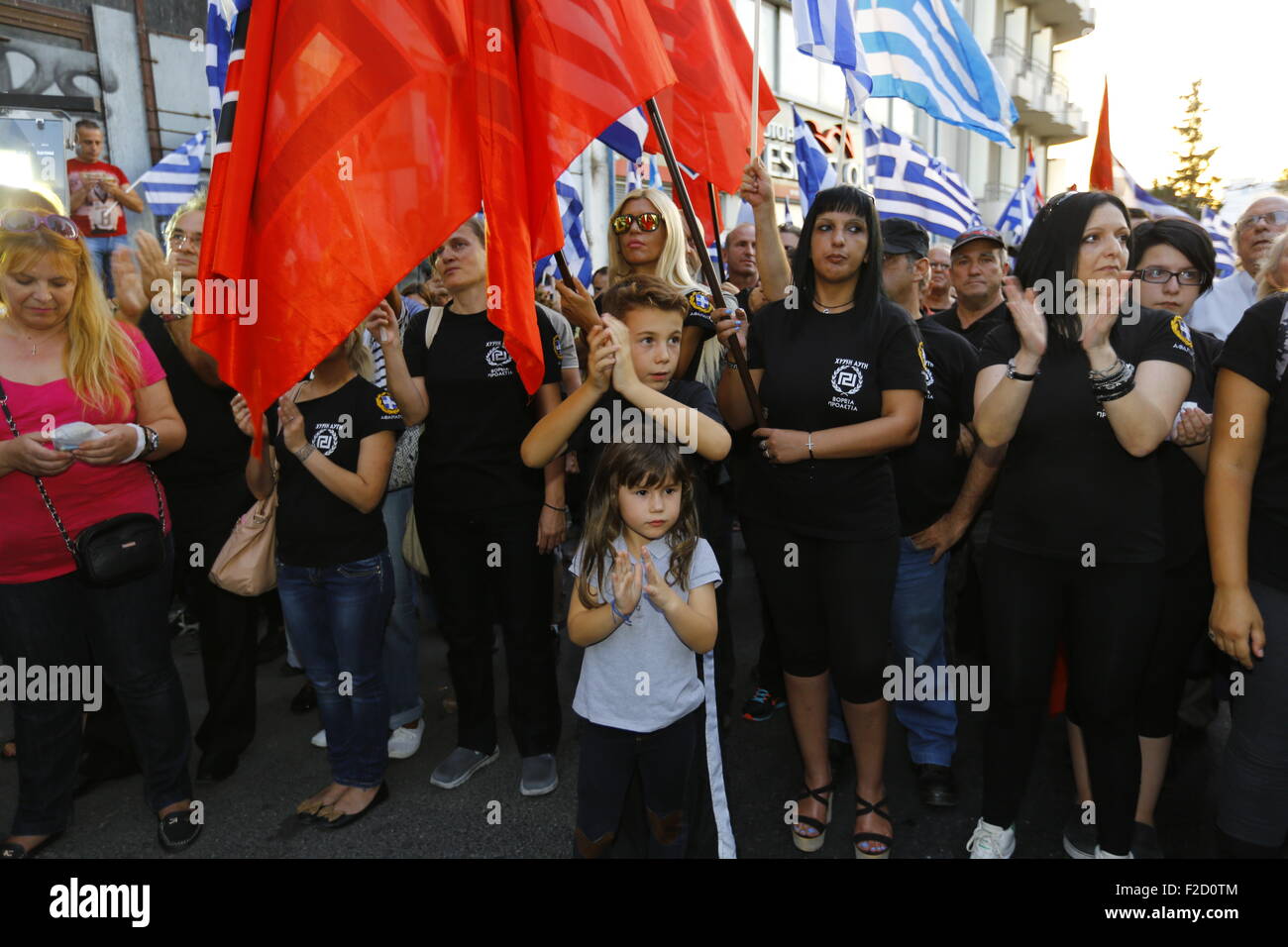Athens, Greece. 16th September 2015. A boy and a girl attend the Golden Dawn election rally. Greek right wing  party Golden Dawn held an election rally in Athens, four days ahead of election day. The party hopes to gain enough seats in the election to become the third latest party in the Greek Parliament. Credit:  Michael Debets/Alamy Live News Stock Photo