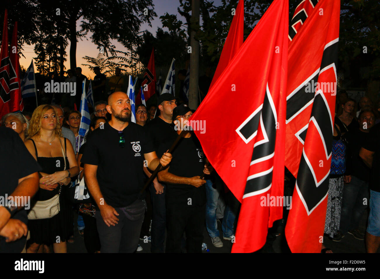 Athens, Greece. 16th September 2015. Golden Dawn supporter carry Golden Dawn flags the election rally in Athens. Greek right wing  party Golden Dawn held an election rally in Athens, four days ahead of election day. The party hopes to gain enough seats in the election to become the third latest party in the Greek Parliament. Credit:  Michael Debets/Alamy Live News Stock Photo