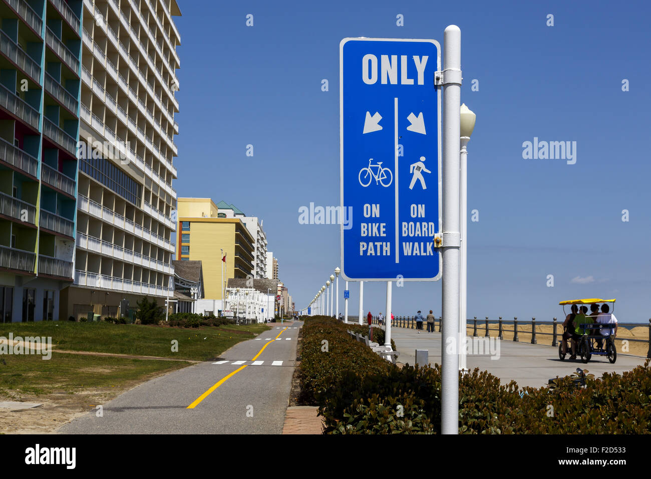 Dedicated bicycle and walking paths sign on boardwalk Virginia Beach USA Stock Photo