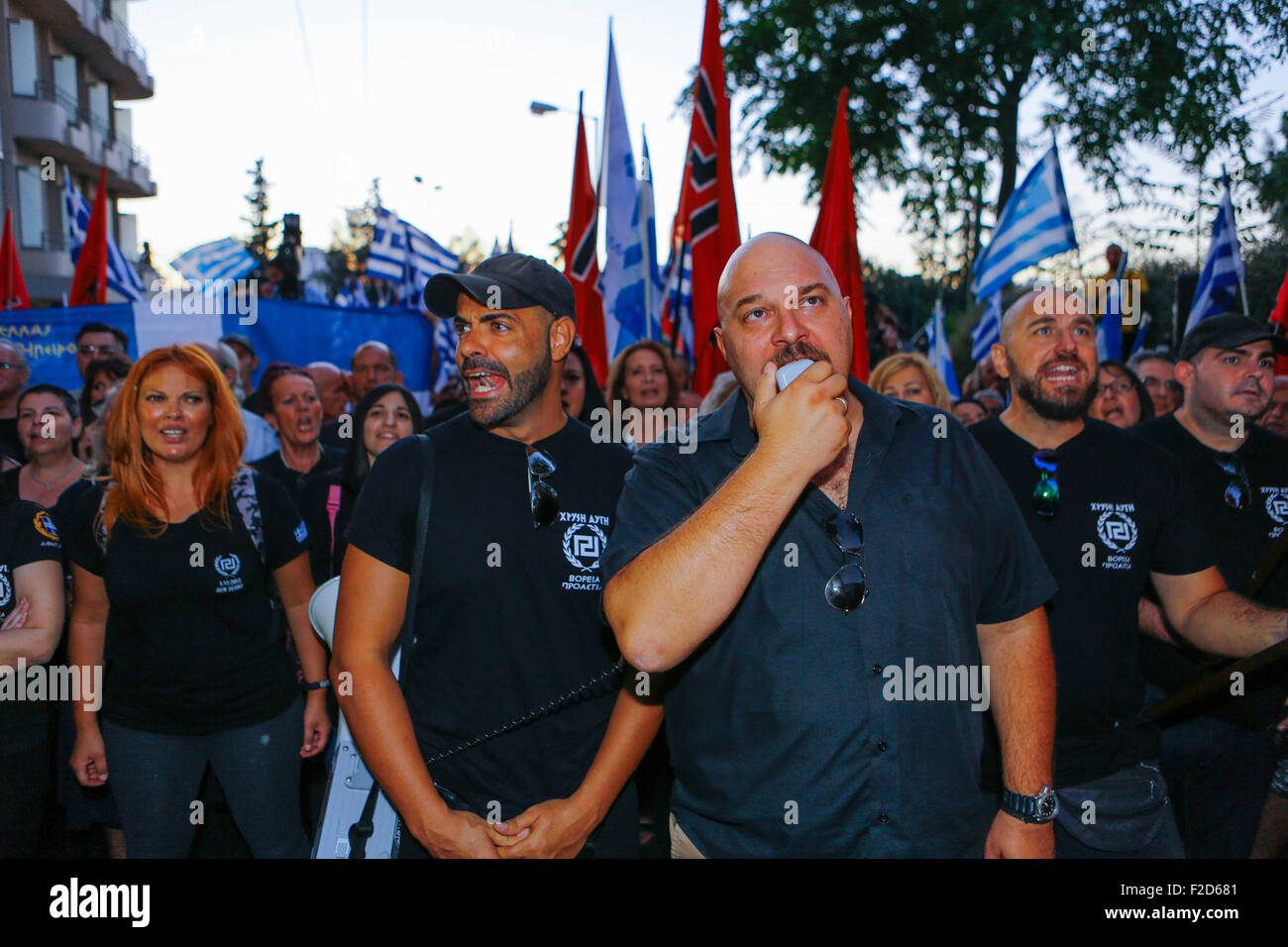 Athens, Greece. 16th Sep, 2015. Golden Dawn MP (Member of Parliament) Ilias Panagiotaros (right) shouts slogans at the election rally through a megaphone. Greek right wing party Golden Dawn held an election rally in Athens, four days ahead of election day. The party hopes to gain enough seats in the election to become the third latest party in the Greek Parliament. Credit:  Michael Debets/Pacific Press/Alamy Live News Stock Photo