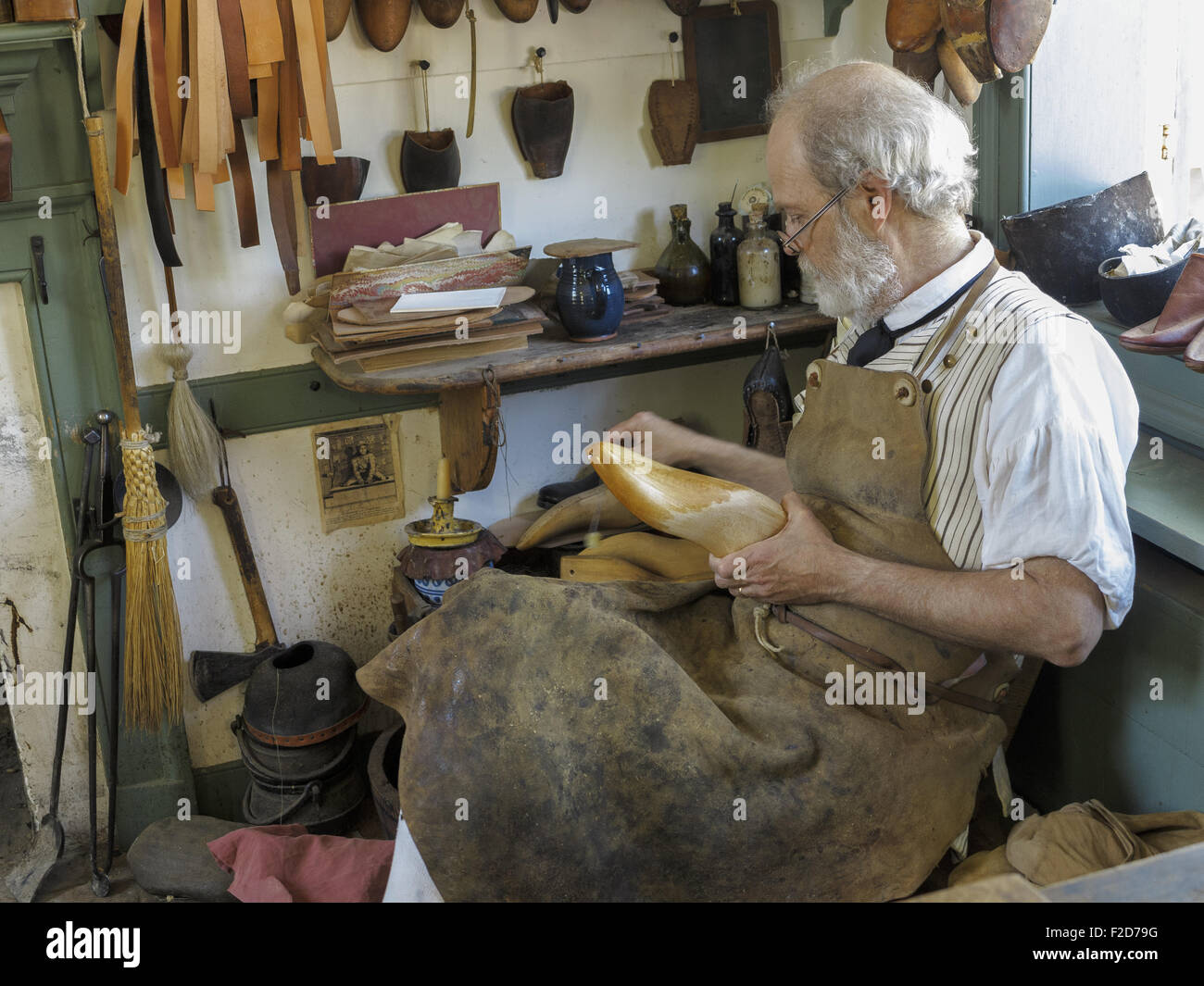 Traditional shoemaker finishing a mould for a shoe Colonial Williamsburg living-history museum Virginia USA Stock Photo