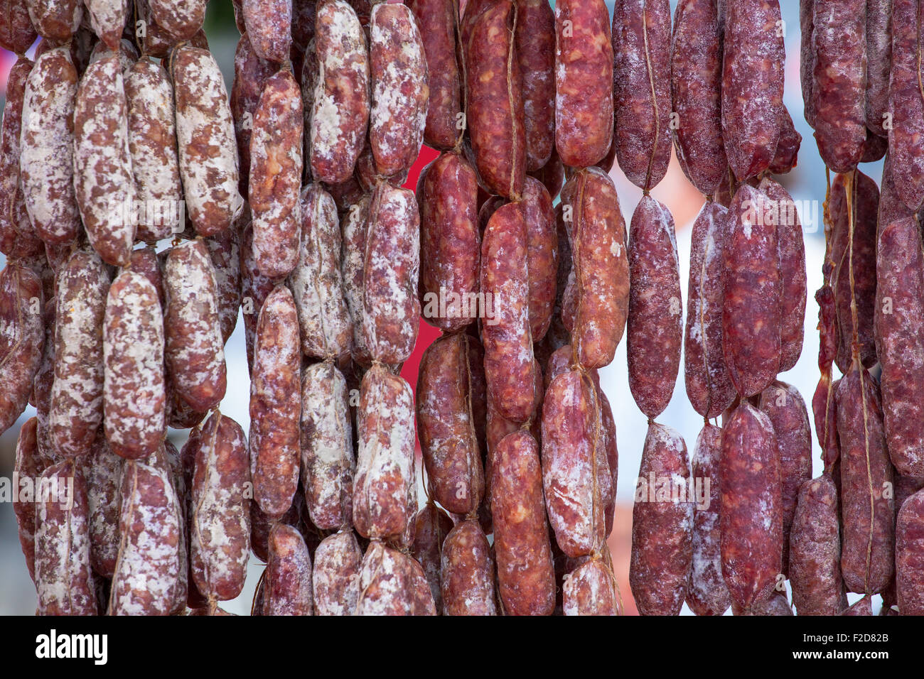 Close up of delicious Italian salami hanging on the rope Stock Photo