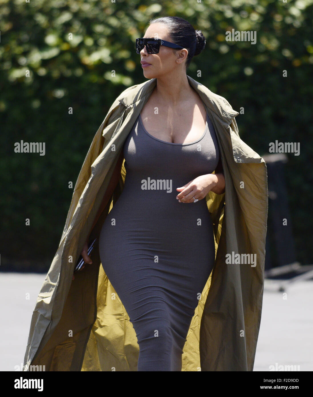 Pregnant KIM KARDASHIAN sports a skin tight dress and a trench whilst out with friends in West Hollywood.  Featuring: Kim Kardashian Where: Los Angeles, California, United States When: 17 Jul 2015 Stock Photo