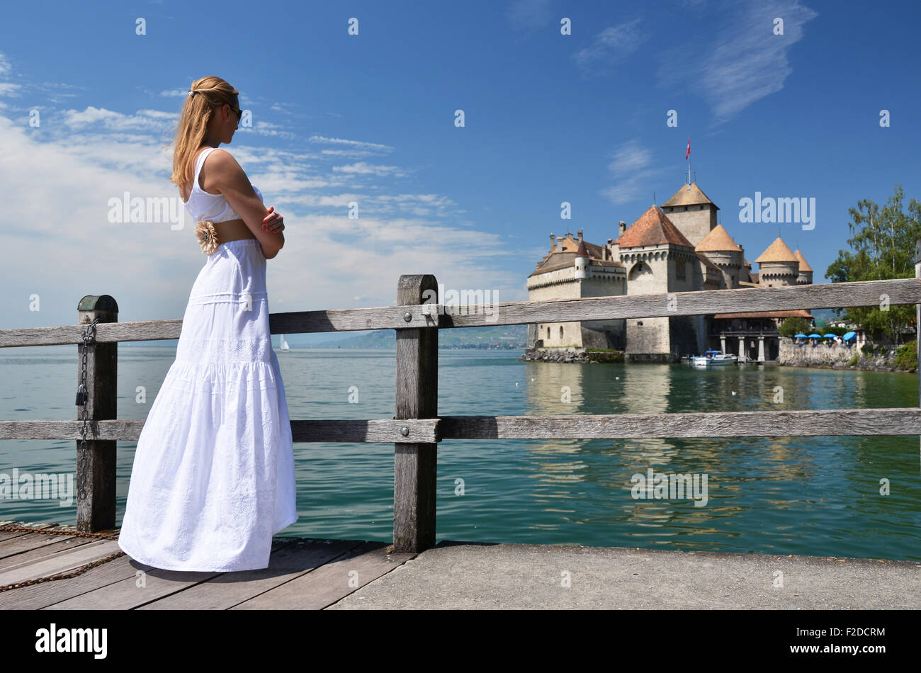 Young woman looking at Chillion castle, Switzerland Stock Photo