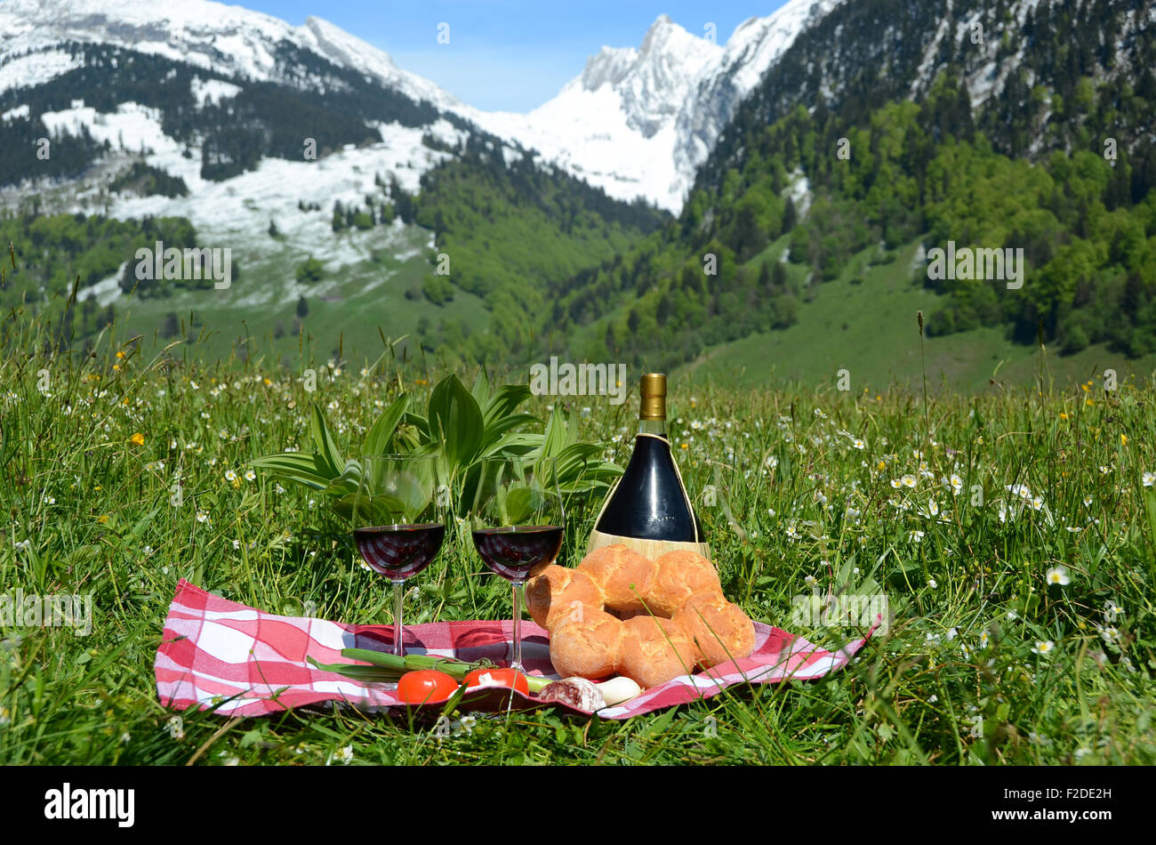 Wine and vegetables served at picnic on Alpine meadow. Switzerland Stock Photo Alamy