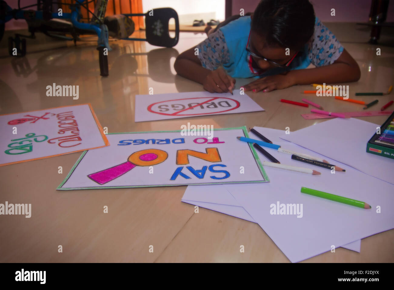 Child making posters against drugs Stock Photo