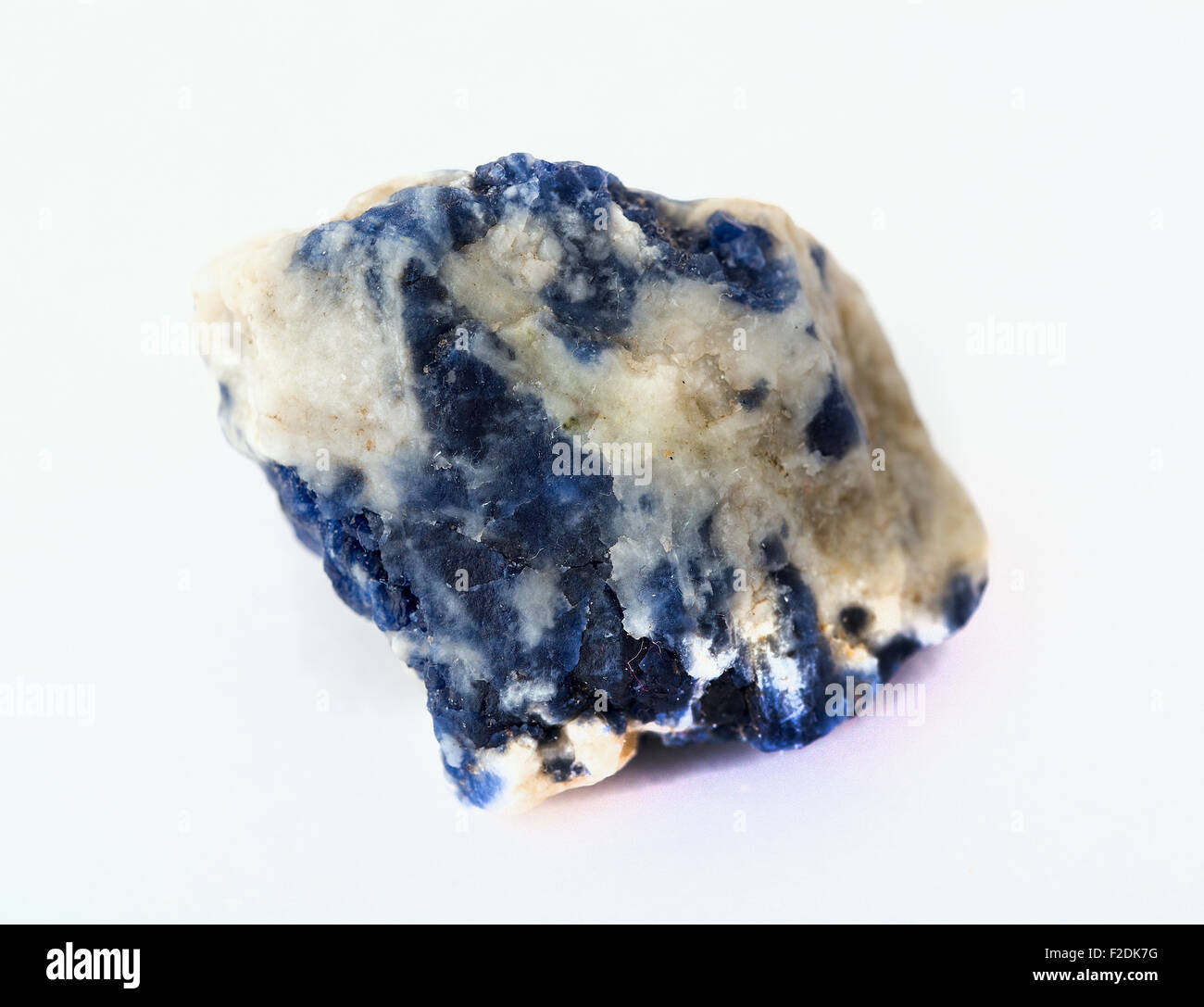 Raw sodalite stone isolated on white background Stock Photo - Alamy