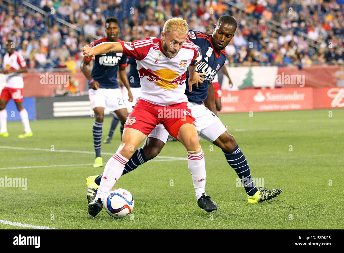 Foxborough, Massachussetts, USA. 16th September, 2015. New England Revolution defender Jose Goncalves (23) and New York Red Bulls forward Mike Grella (13) in action during the first half of the MLS game between the New England Revolution and New York Red Bulls at Gillette Stadium. Credit:  Cal Sport Media/Alamy Live News Stock Photo