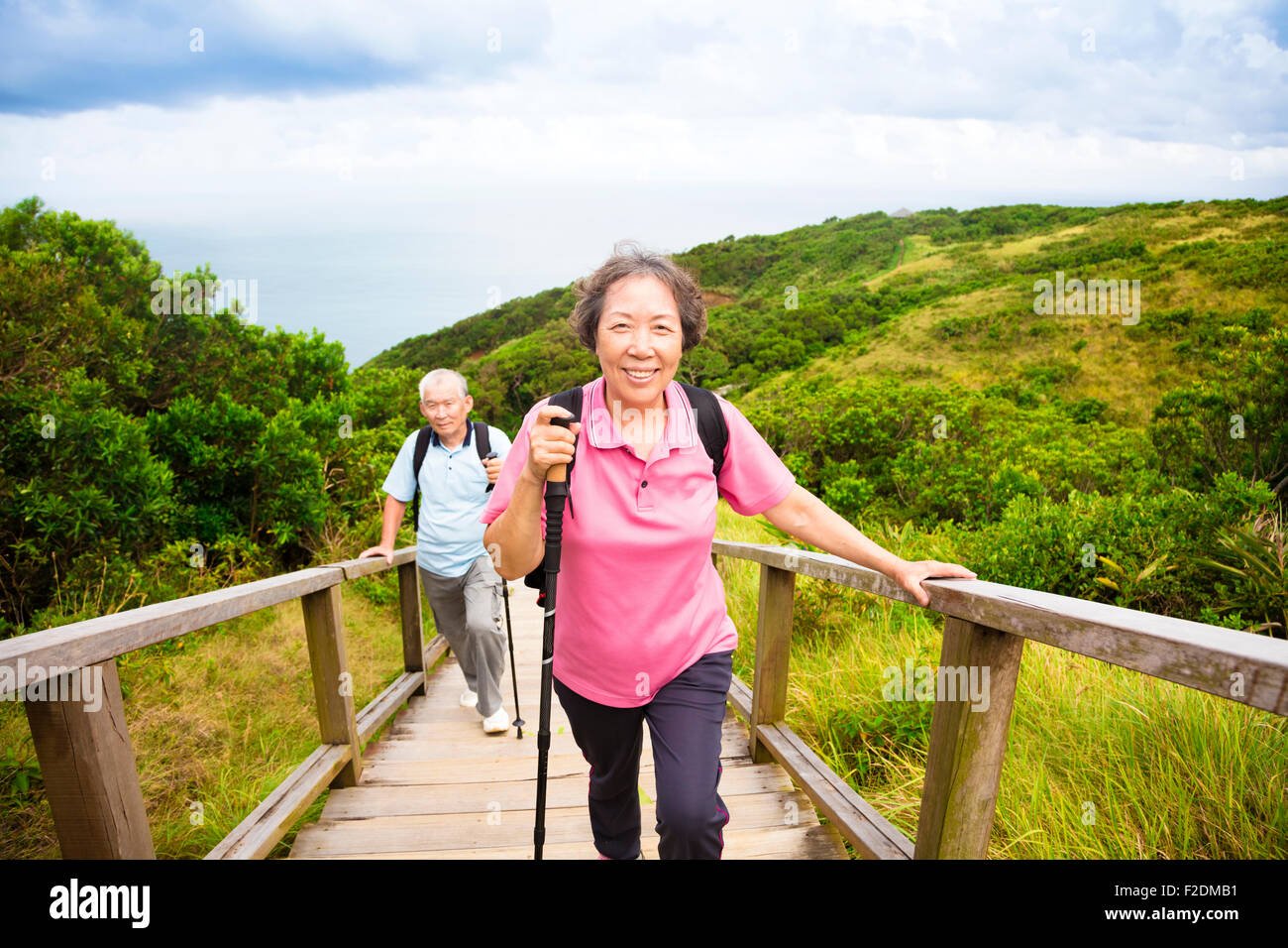 happy senior couple hiking on the mountain park Stock Photo - Alamy