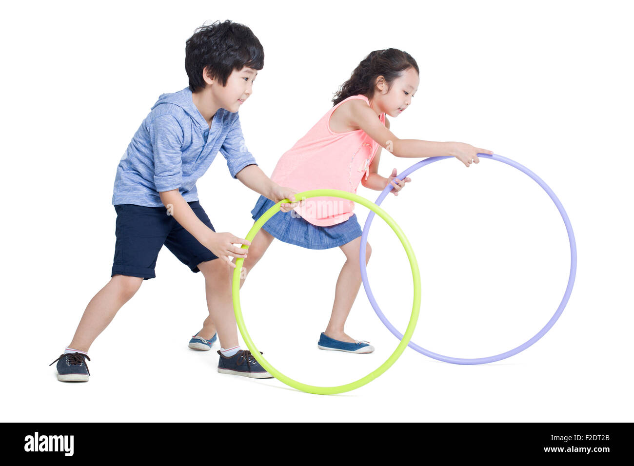 Happy children rolling plastic hoops Stock Photo Alamy