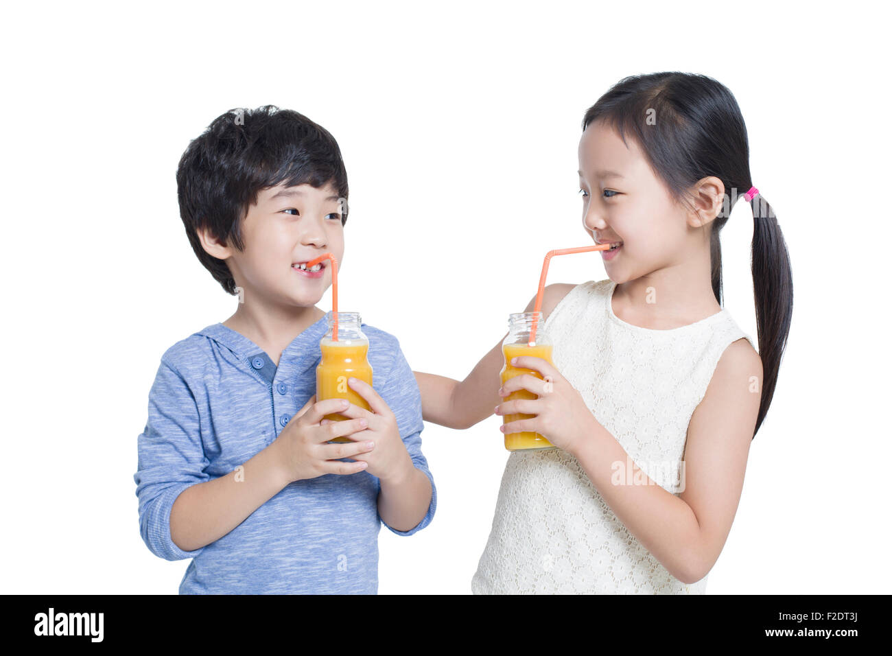 Happy children drinking juice Stock Photo - Alamy
