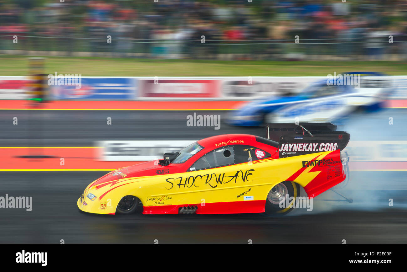 Top Fuel Funny car drag race at Santa Pod. Kevin Kent in a Ford Mustang far side v Gordon Smith driving a Dodge Stratus nearside Stock Photo