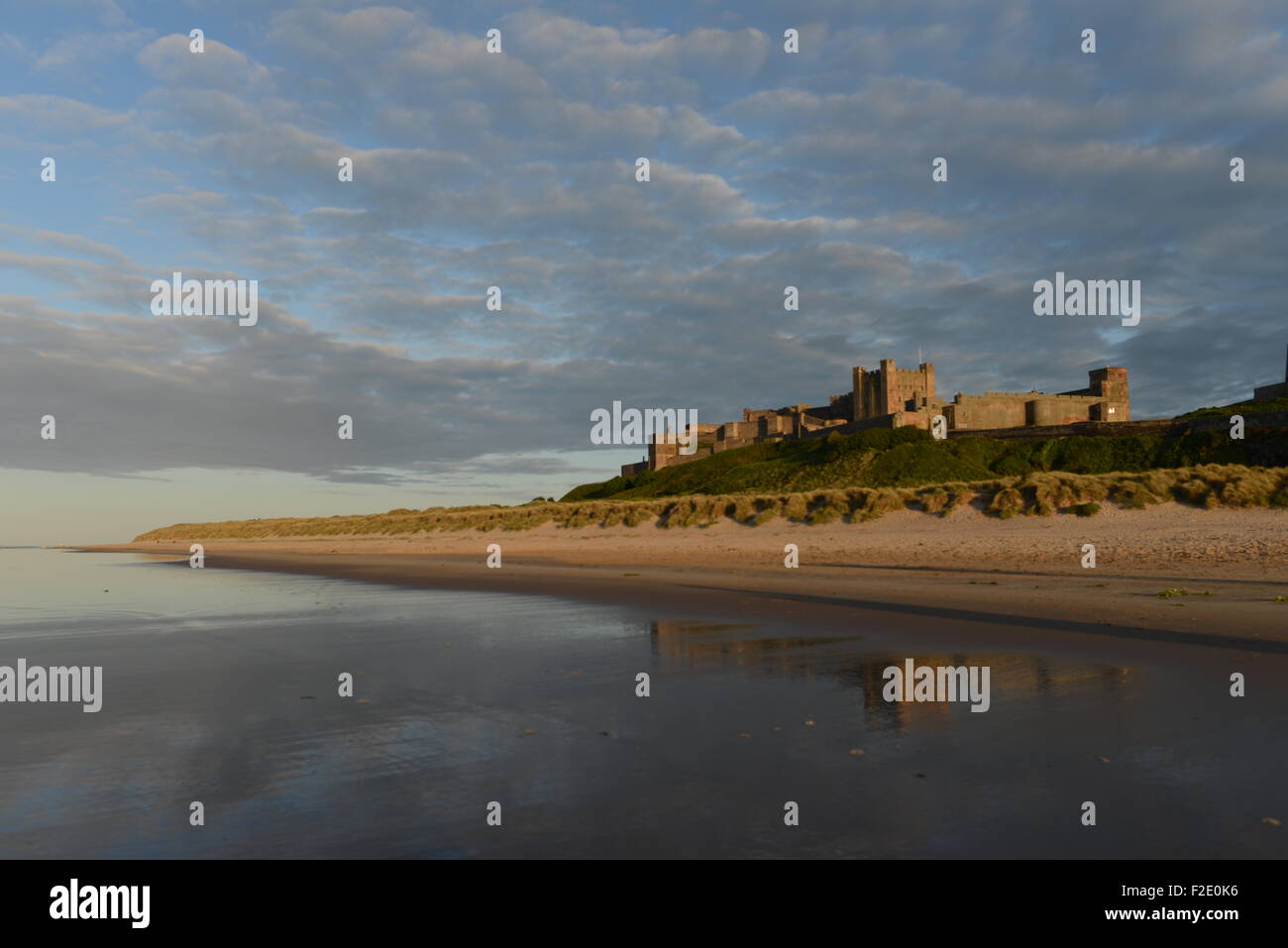 bamburgh castle reflections in a golden sunset Stock Photo
