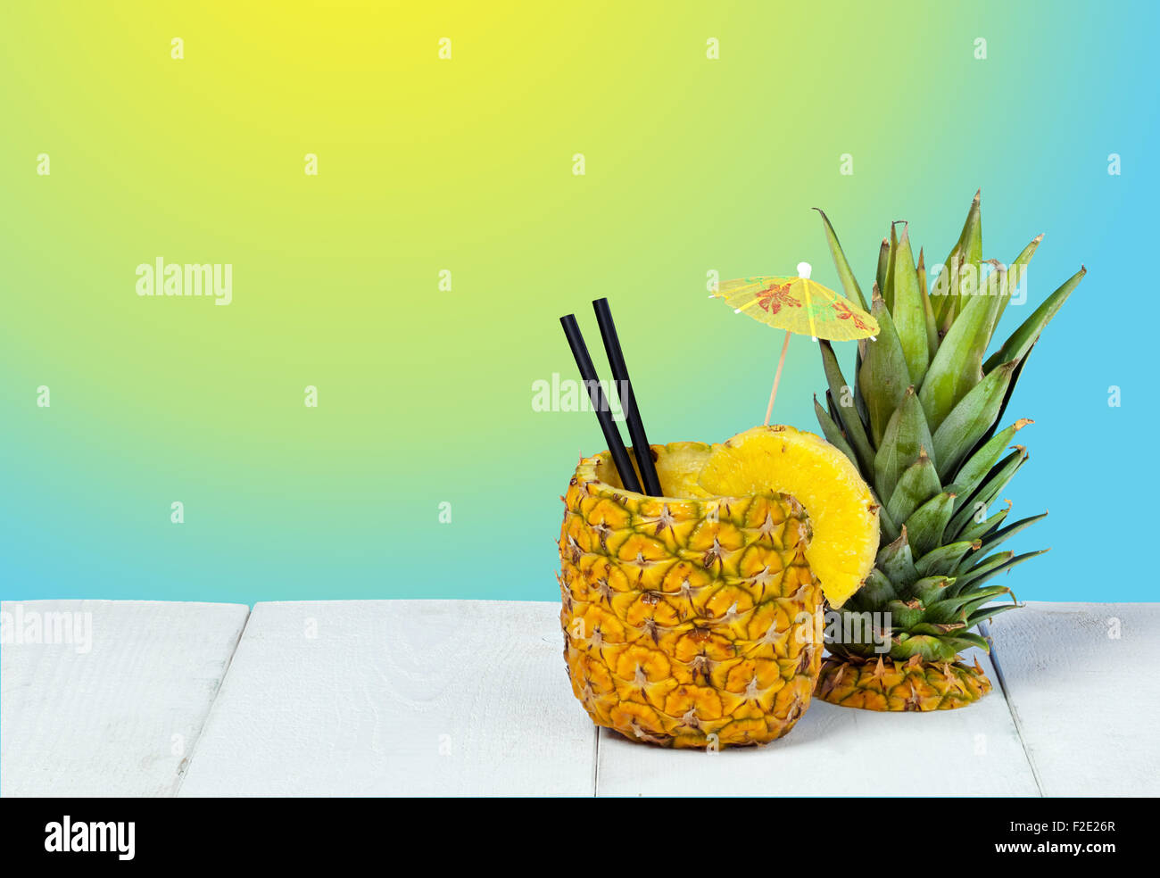 Pineapple juice served in the peel on background gradient Stock Photo ...