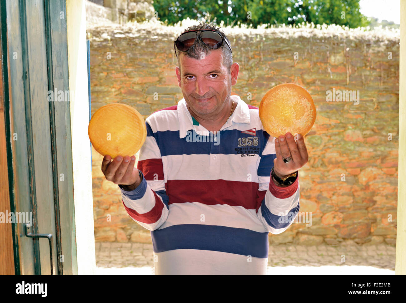 Portugal: Mr. Mario Robalo showing traditional cheese in his shop in Idanha-a-Velha Stock Photo