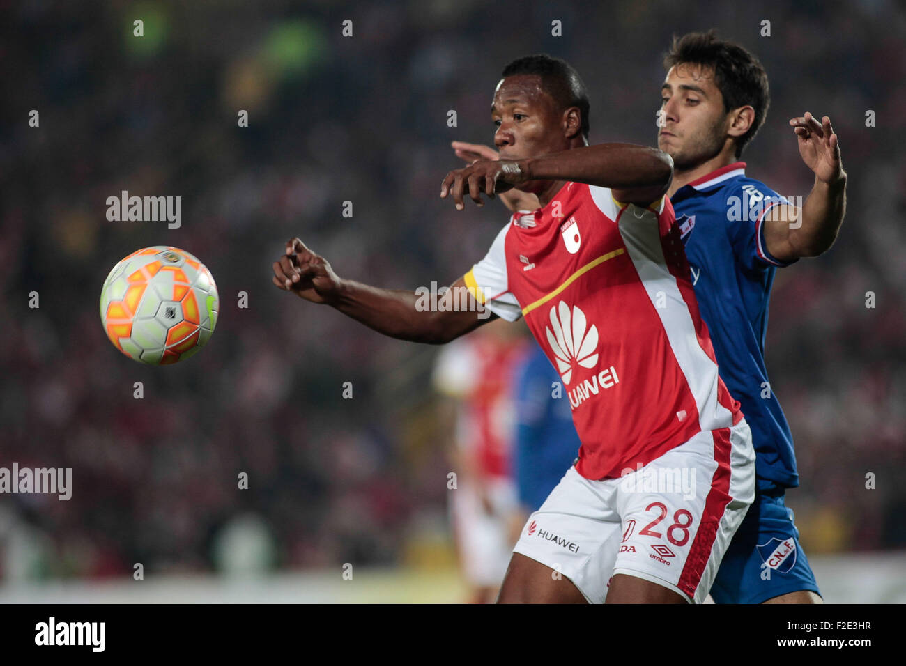 Bogota, Colombia. 16th Sep, 2015. Independiente Santa Fe's Daniel Angulo (L), of Colombia, vies with Sebastian Gorca of Uruguay's Nacional, during the second phase match of the South American Cup, held in the Nemesio Camacho 'El Campin' Stadium, in Bogota City, Colombia, on Sept. 16, 2015. Credit:  Jhon Paz/Xinhua/Alamy Live News Stock Photo