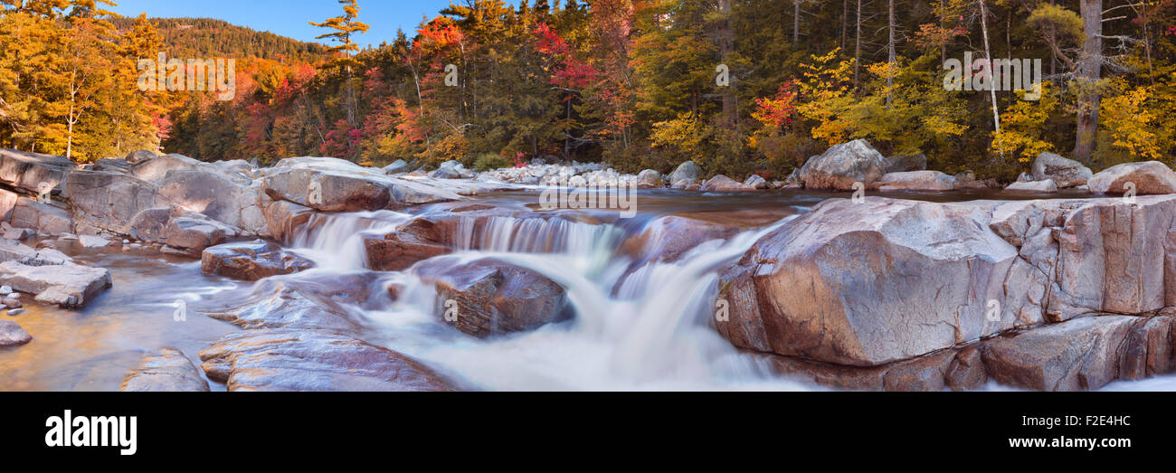 Multi-coloured fall foliage along the Swift River Lower Falls, White Mountain National Forest in New Hampshire, USA. Stock Photo