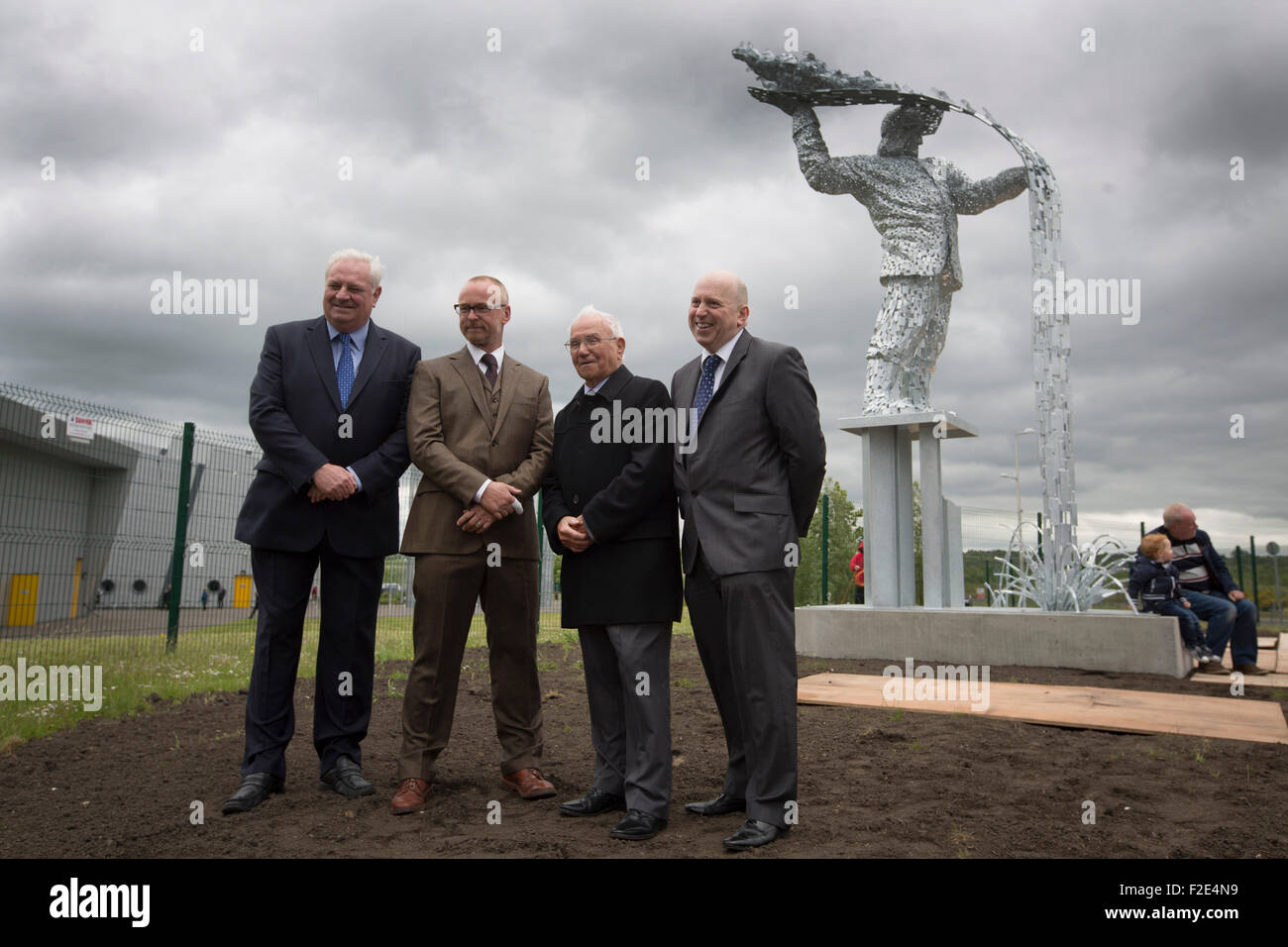 Artist Andy Scott (second left) with Terry Currie, Tommy Brennan and John Scott pictured at the official unveiling of Steel Man, his new sculpture made to commemorate those who lost their lives in the iron and steel industry in Scotland. The memorial was sited at Ravenscraig in Lanarkshire, on the site of Europe's largest former hot strip mill, which closed in 1992. The site was cleared in 1996 and now houses a sports centre, college and housing. Stock Photo