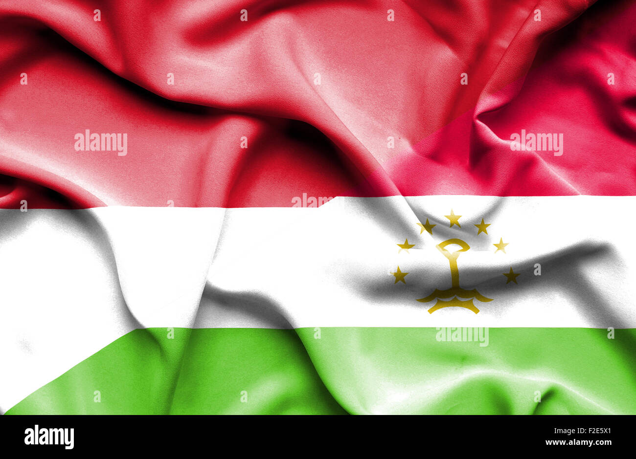 Waving flag of Tajikistan and Monaco Stock Photo
