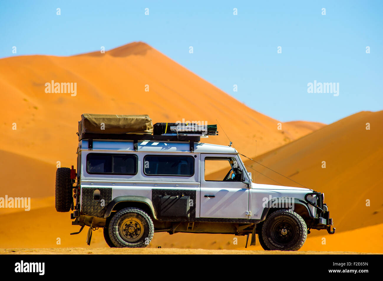 Land Rover Defender 110 parked in the desert with dunes in the distance in  Sossusvlei, Namibia, Africa Stock Photo - Alamy