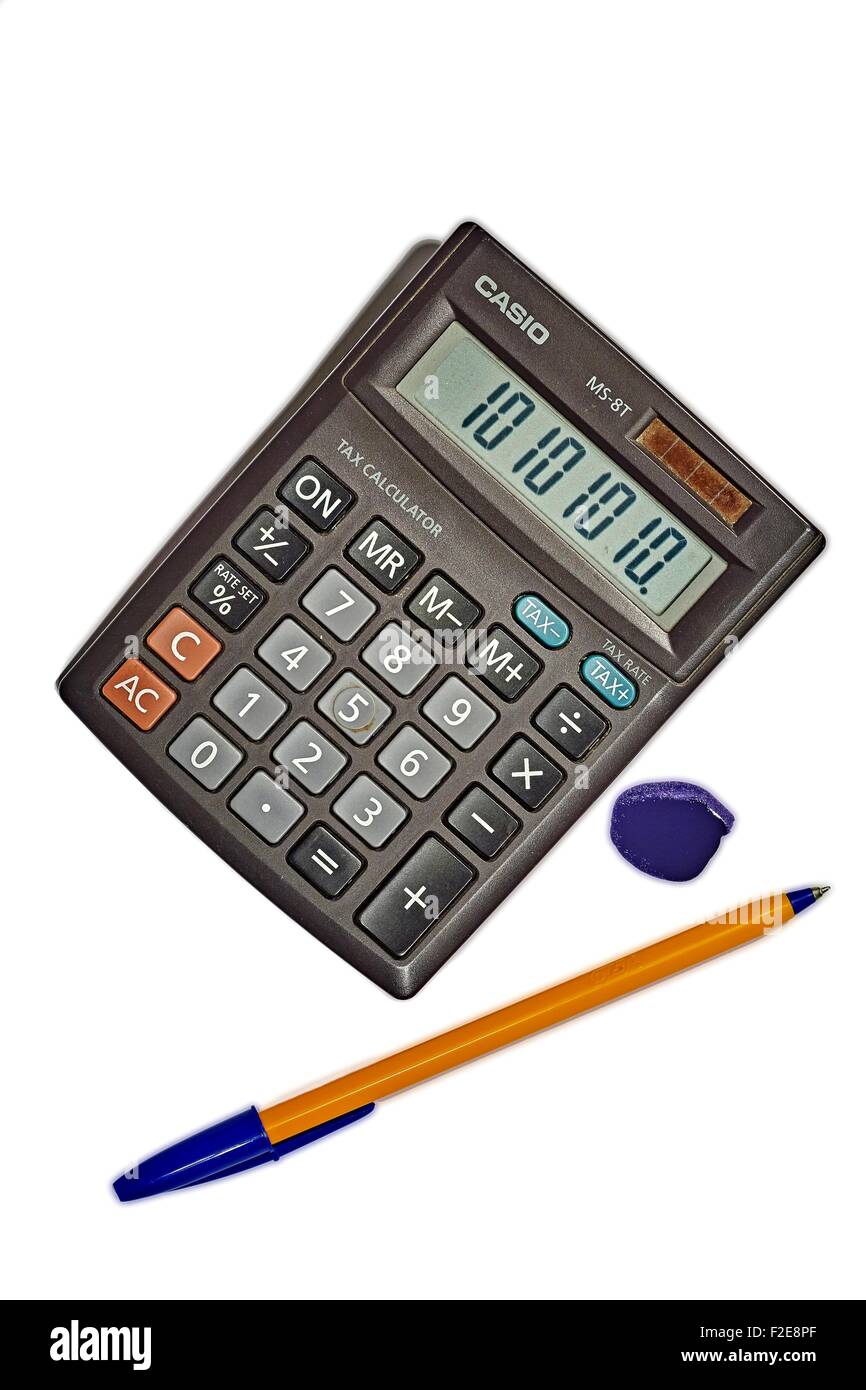 Solar Powered Calculator and blue Biro with blue ink blot Stock Photo