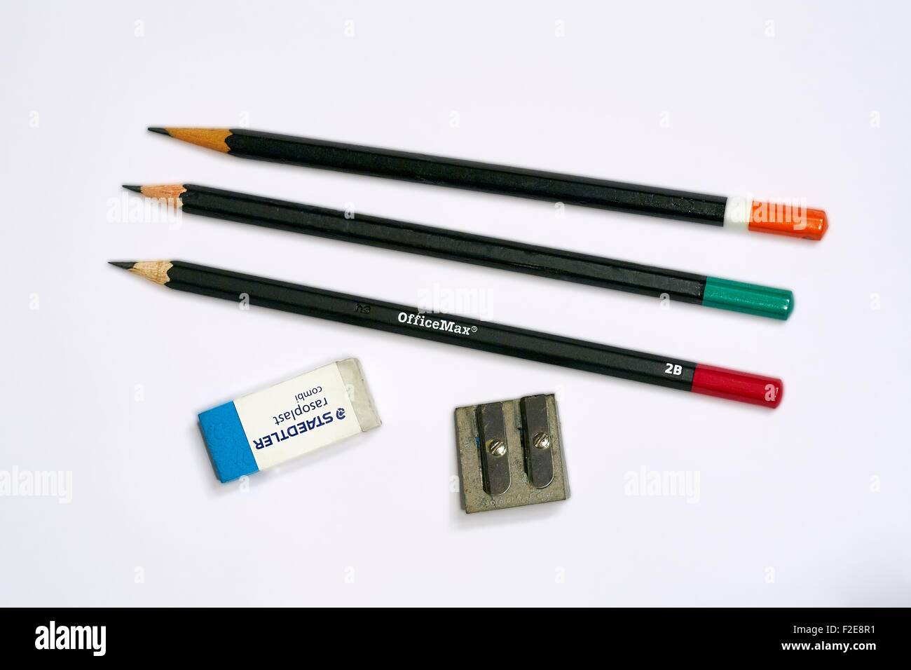 Three 2B Pencils with an Eraser and Pencil Sharpener as required to sit any standard test, quiz or examination Stock Photo
