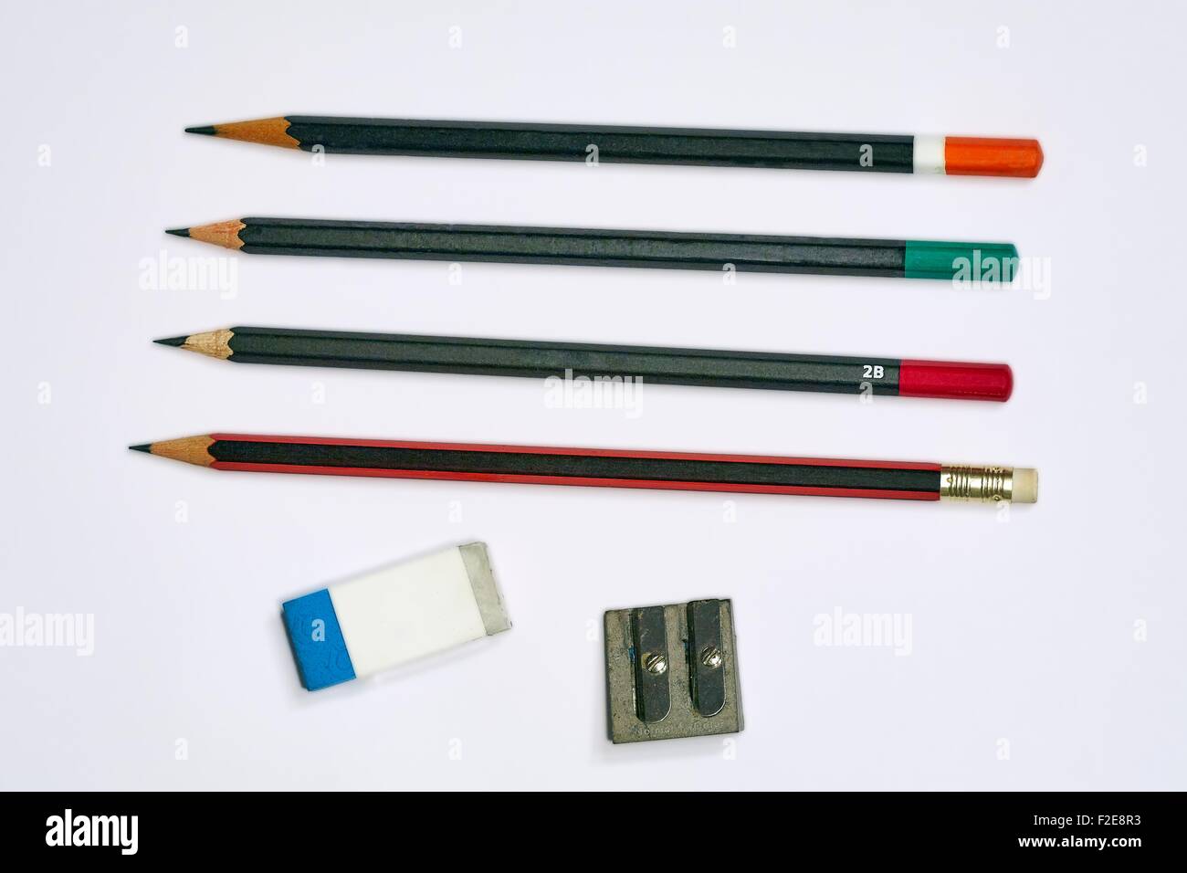 Four Traditional Pencils with an Eraser and a Pencil Sharpener Stock Photo