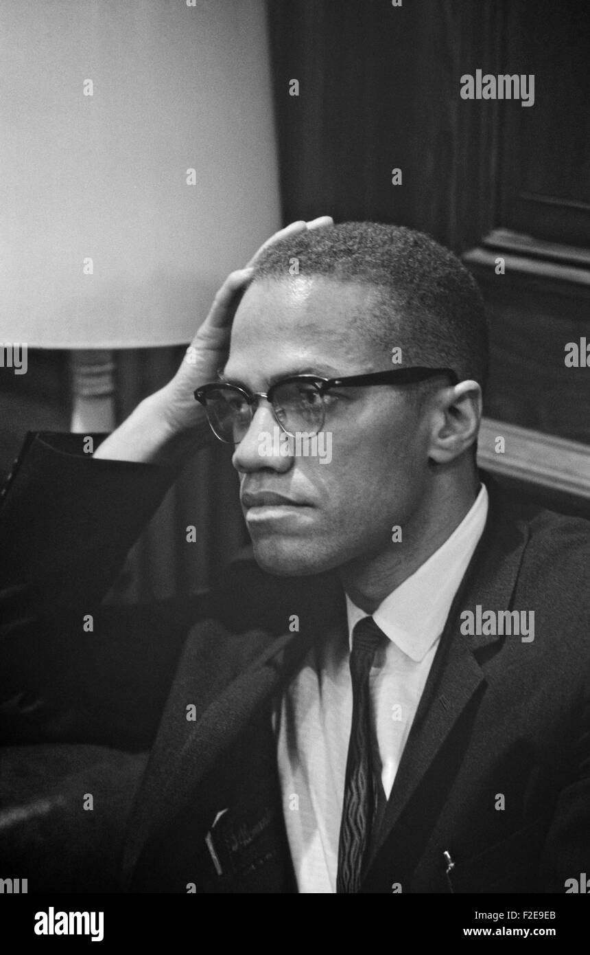 Civil rights leader Malcolm X waits to greet the Rev. Martin Luther King, Jr. during a press conference in the U.S. Capitol March 26, 1964 in Washington, DC. King discussed the Civil Rights Bill being debated by the United States Senate. Stock Photo
