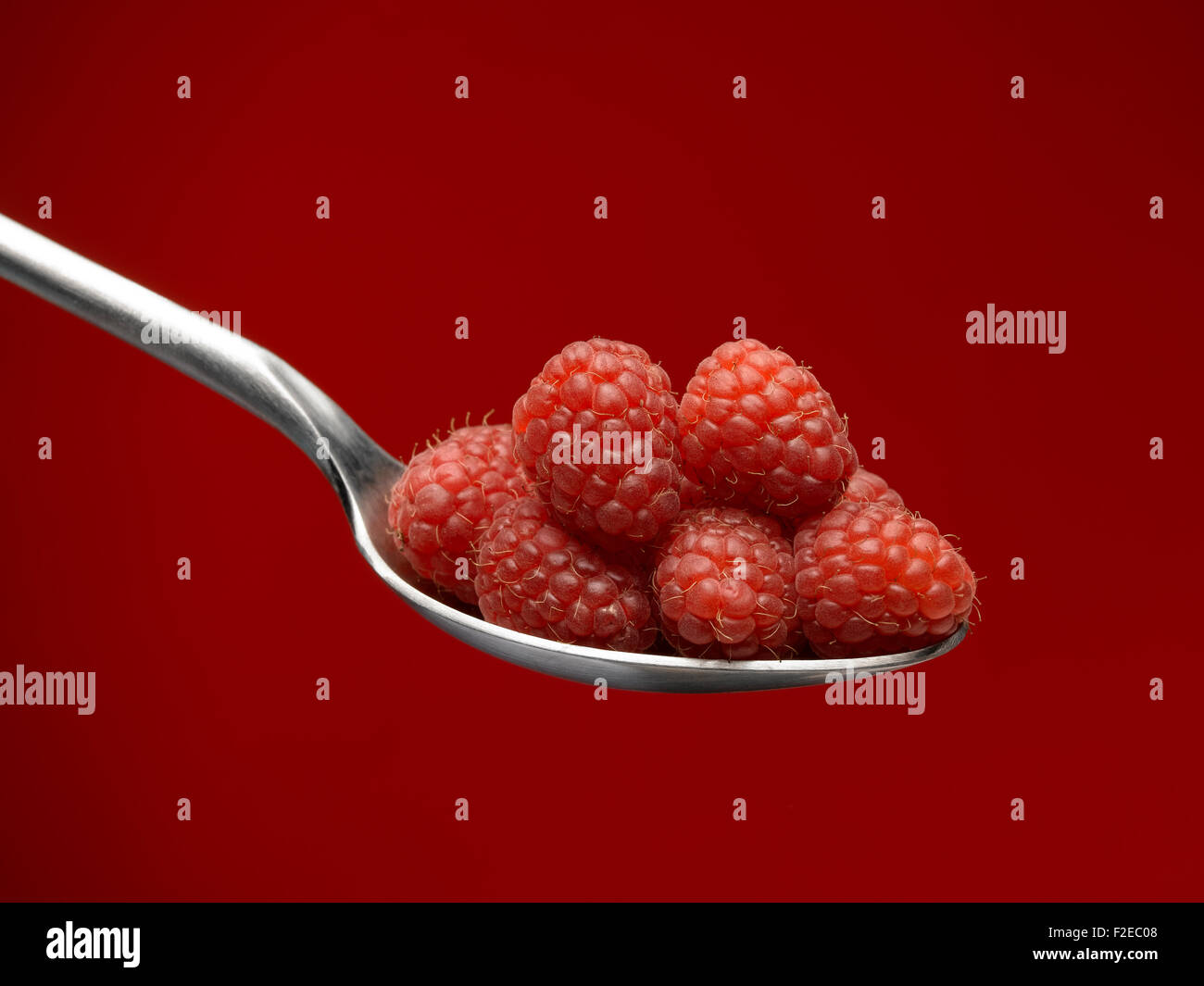 Raspberry on spoon Stock Photo - Alamy
