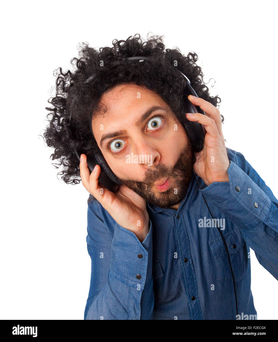 Young surprised man with headphones on white background. Stock Photo