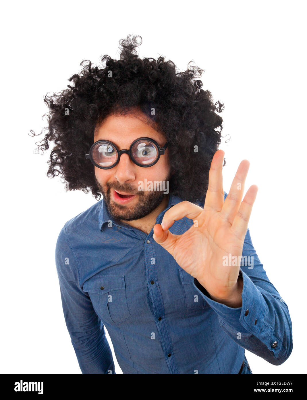 Man with crazy expression making gesture ok on white background. Stock Photo