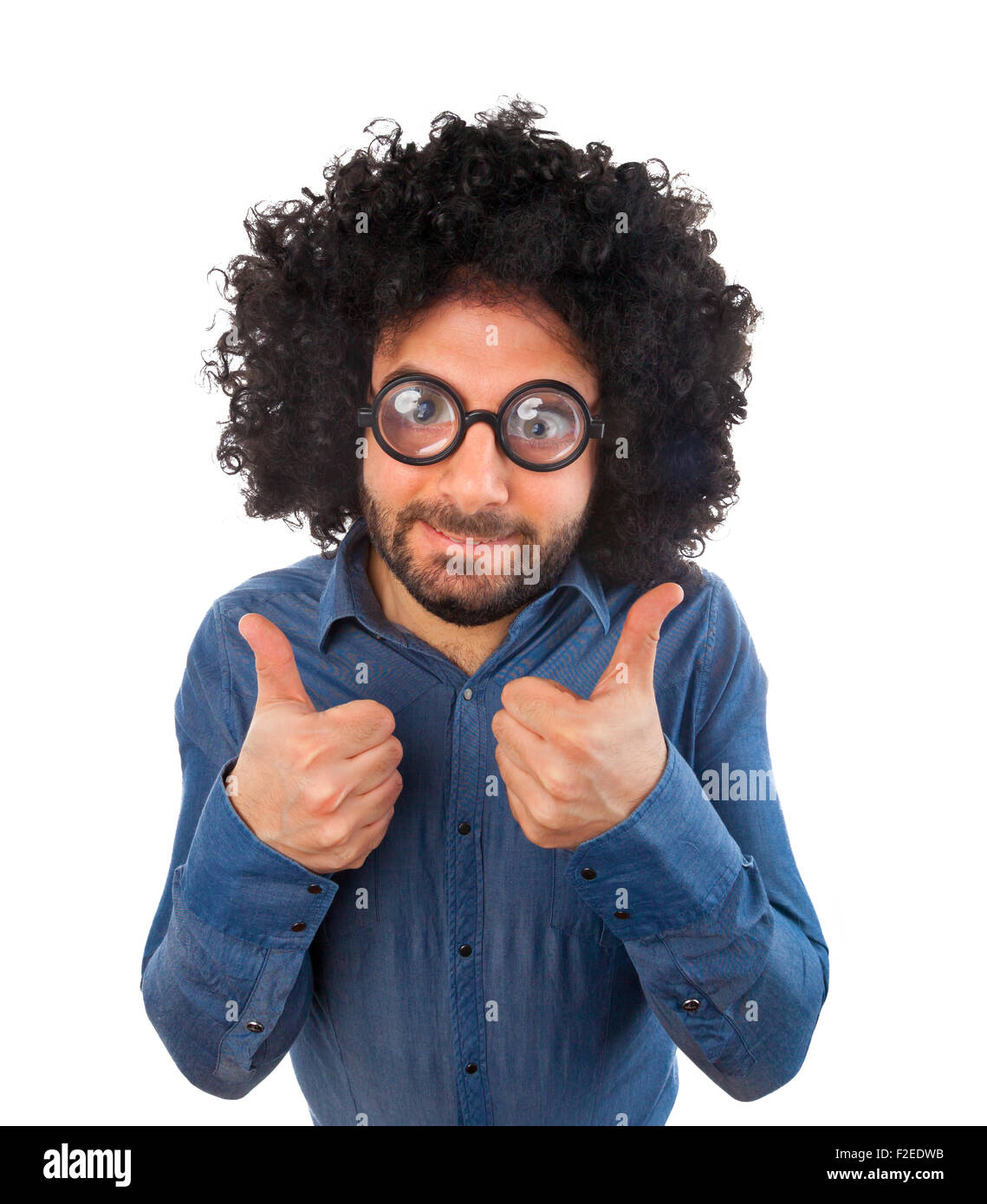 Man with crazy expression and thumb up on white background. Stock Photo