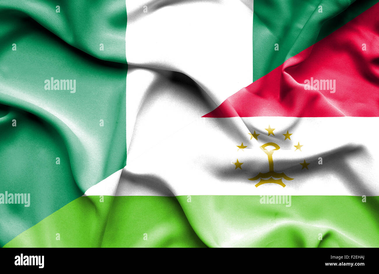 Waving flag of Tajikistan and Nigeria Stock Photo