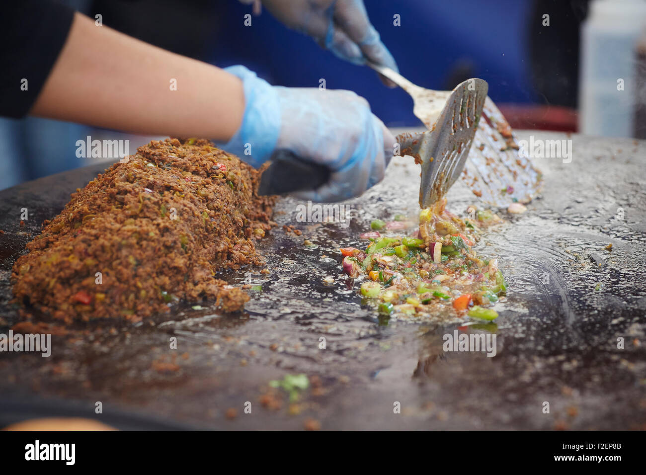 Mixing street food curry at artisan food market festival cooking Stock Photo