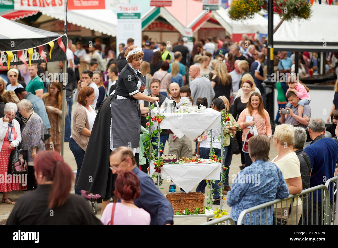 ALDI sponsored 10th Bolton Food and Drink Festival 2015   on stilts large lady maid trolly res coffee china uniform  performing Stock Photo