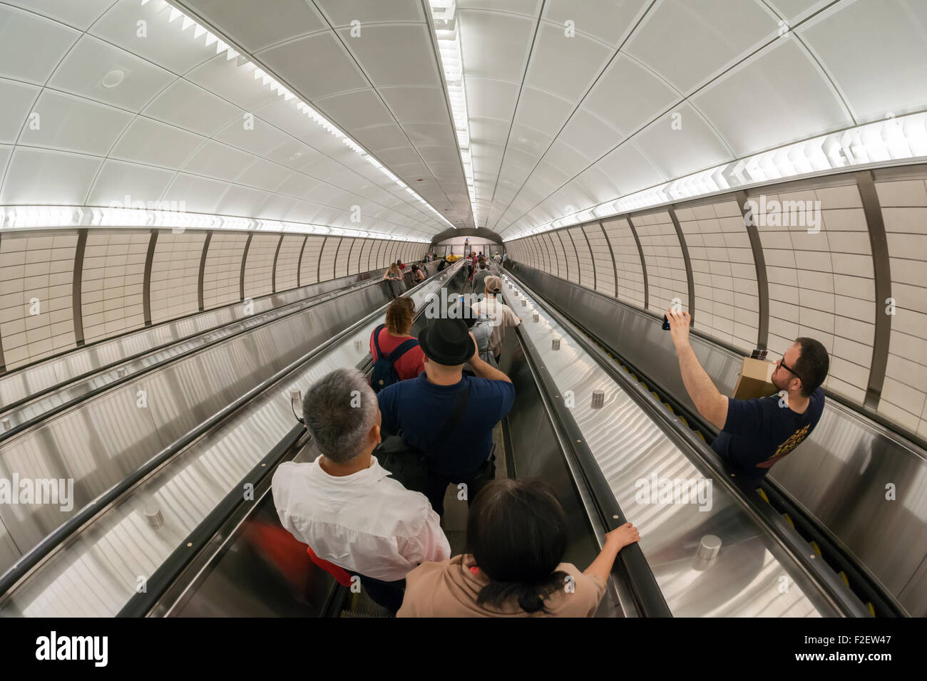 Visitors ride the escalators in the new 34th Street-Hudson Yards terminal station on the 7 Subway line extension in New York on its grand opening, Sunday, September 13, 2015.  The new tunnel from Times Square  terminates 108 feet below street level at West 34th Street and Eleventh Avenue at the doorstep of the rezoned 45 block Hudson Yards development. It is the first subway station to open in 26 years and the first line extension in 60 years. (© Richard B. Levine) Stock Photo