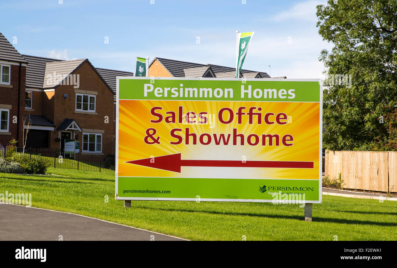 persimmon homes. Large sign in front of new houses on large new housing development with directions to the sales office and showhome Stock Photo