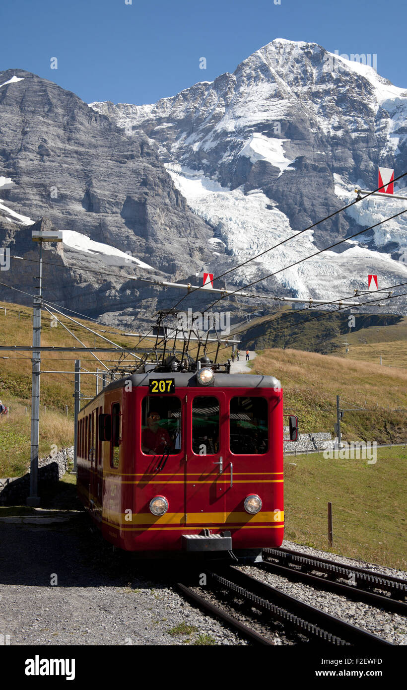 Jungfraubhan train Kleine Scheidegg railway with Mönch in background Switzerland Europe Stock Photo