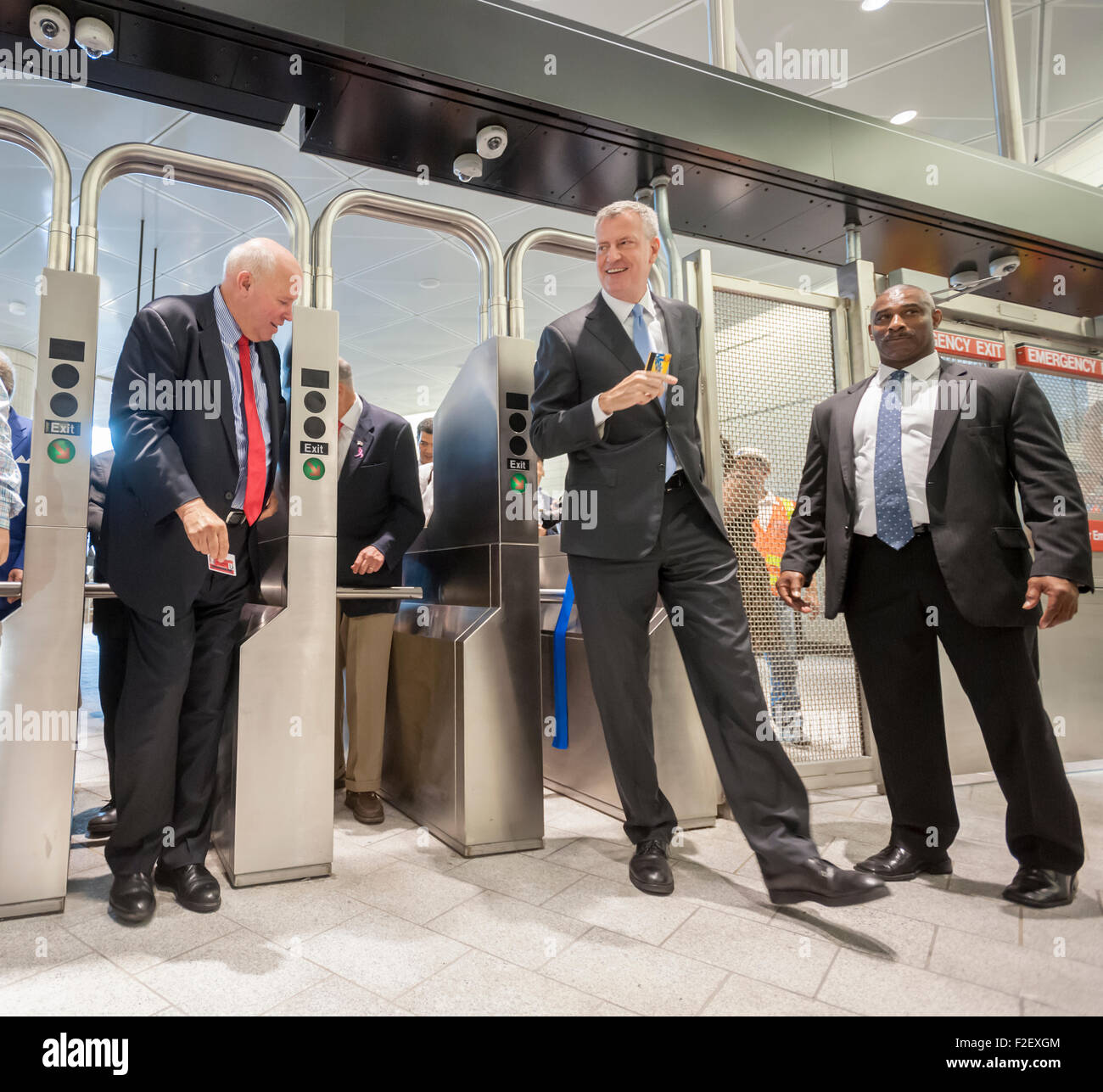 New York Mayor Bill de Blasio, right, with MTA Chair Thomas Prendergast, left, with other officials swipe turnstiles to enter the new 34th Street-Hudson Yards terminal station on the 7 Subway line extension on its grand opening, Sunday, September 13, 2015.  (© Richard B. Levine) Stock Photo